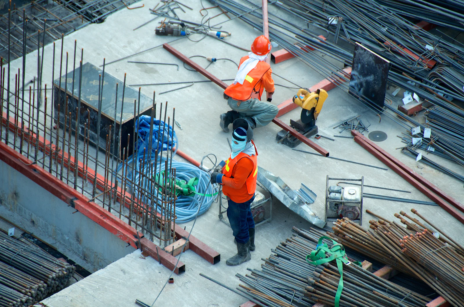 Workers on a construction site, seen from above.