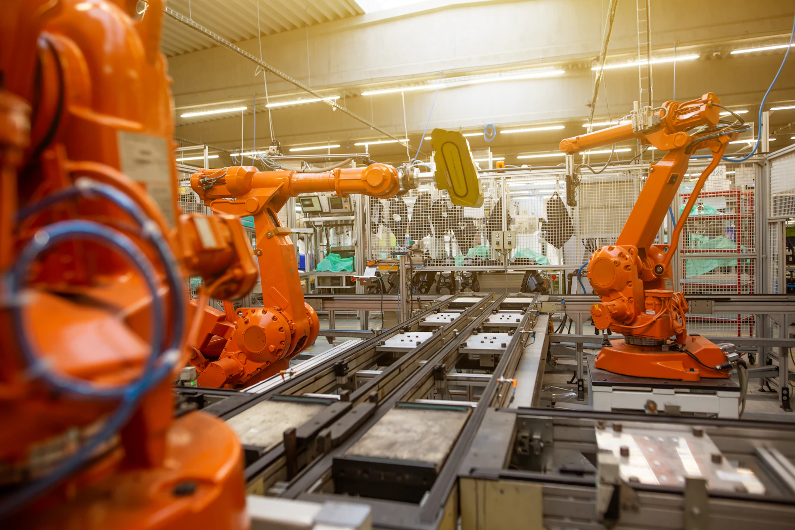 Robotic arms on a production line.